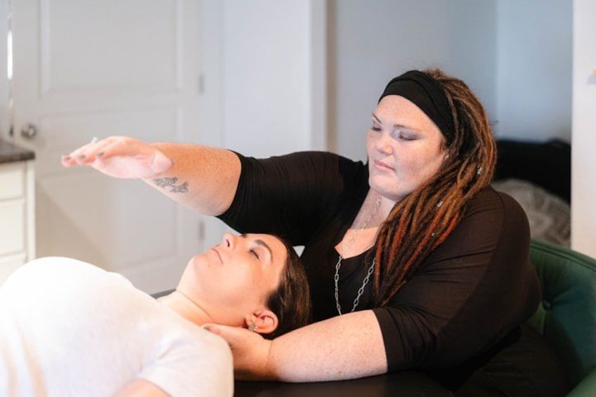 A person lying on a couch receiving a massage. 4