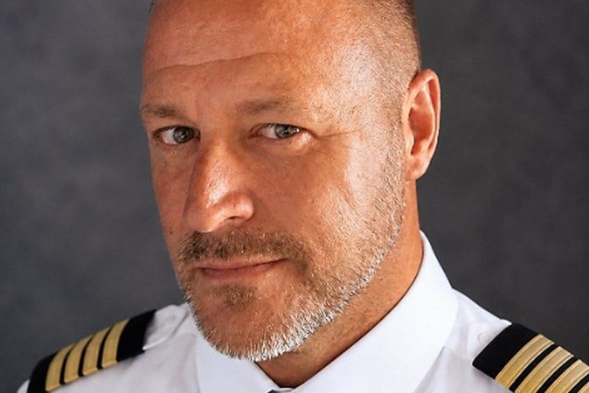 A person in a white uniform with black and gold stripes. 4