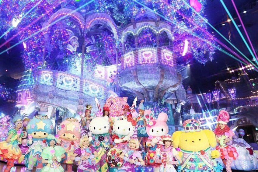 A colorful display with Hello Kitty characters and a large illuminated structure. 5