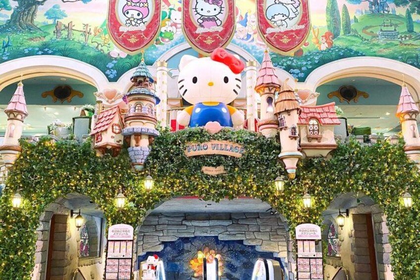 A Hello Kitty themed entrance with a sign reading 'Hello Village' and a large Hello Kitty statue. 2