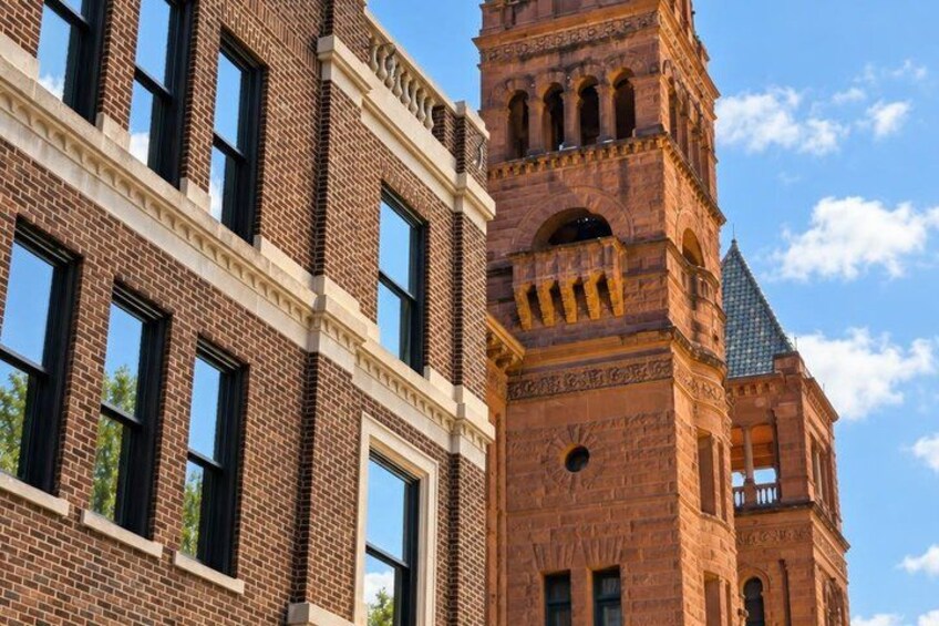 A brick building with a clock tower and arched windows. 2