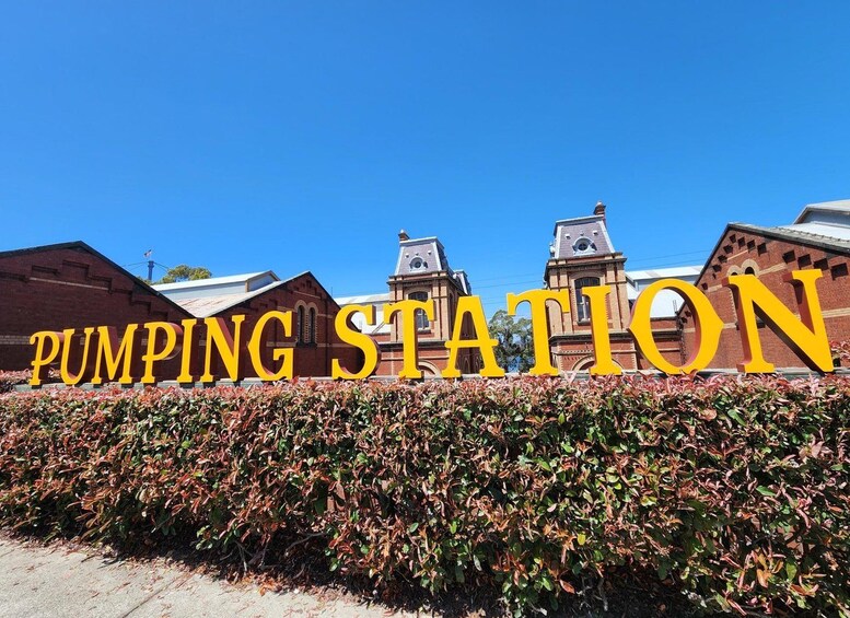 Un grand panneau jaune sur lequel on peut lire les mots « STATION DE POMPAGE », devant un bâtiment doté d’une tour horloge. 5