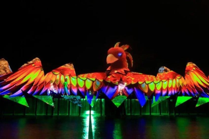 A large, colorful bird sculpture with wings spread wide. 2