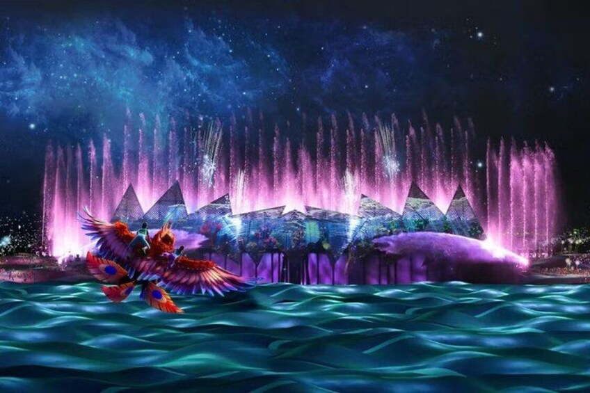 A night scene with a water fountain display, illuminated pyramids, and a dragon-like figure in the foreground. 1