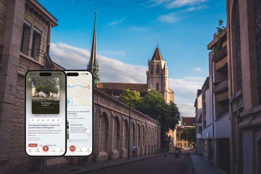 A street with historic buildings, a church spire, and a smartphone displaying a map and information about a nearby attraction. 1