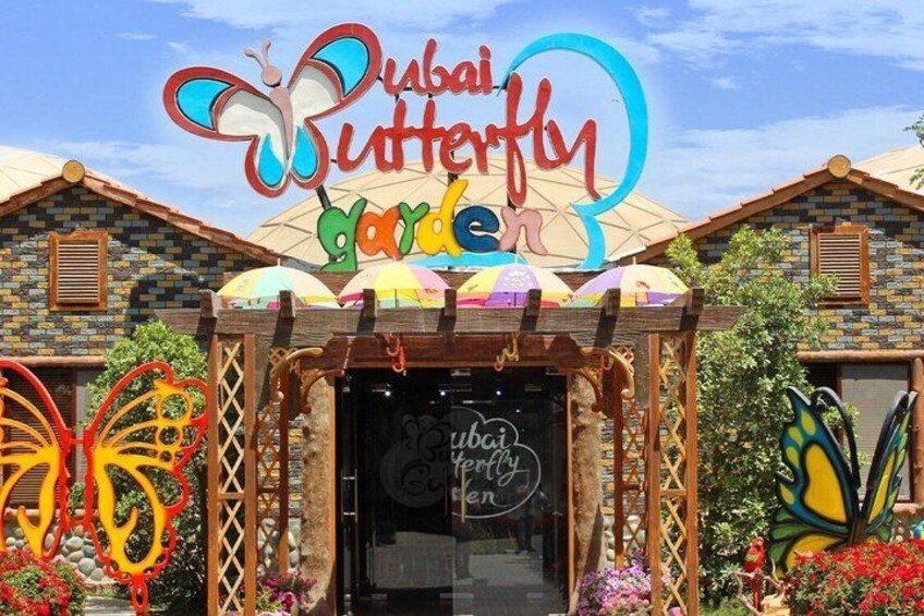 A colorful building with a sign that reads 'Dubai Butterfly Garden.' 5