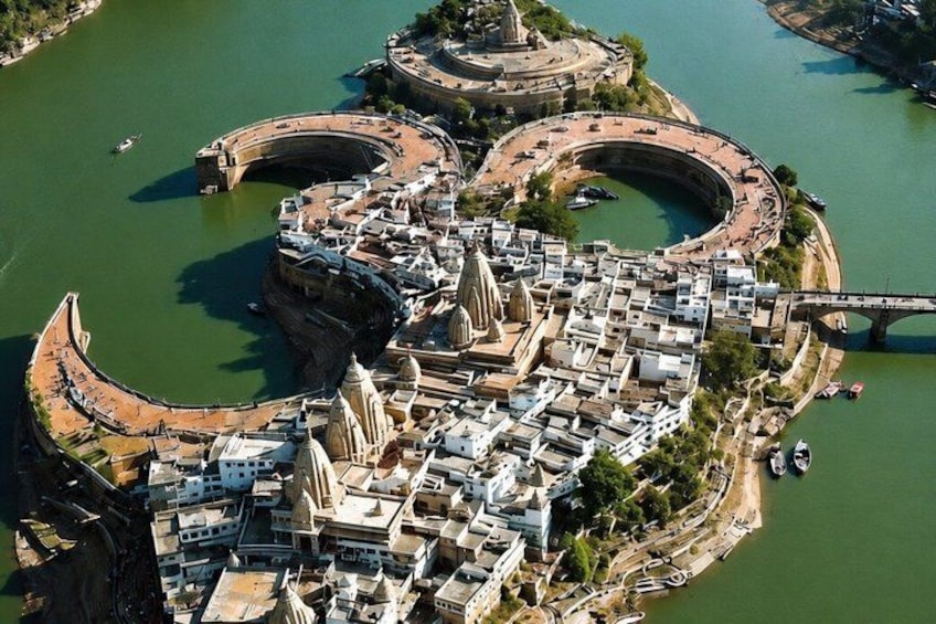 An aerial view of a historic city with a river, bridges, and a prominent cathedral. 1
