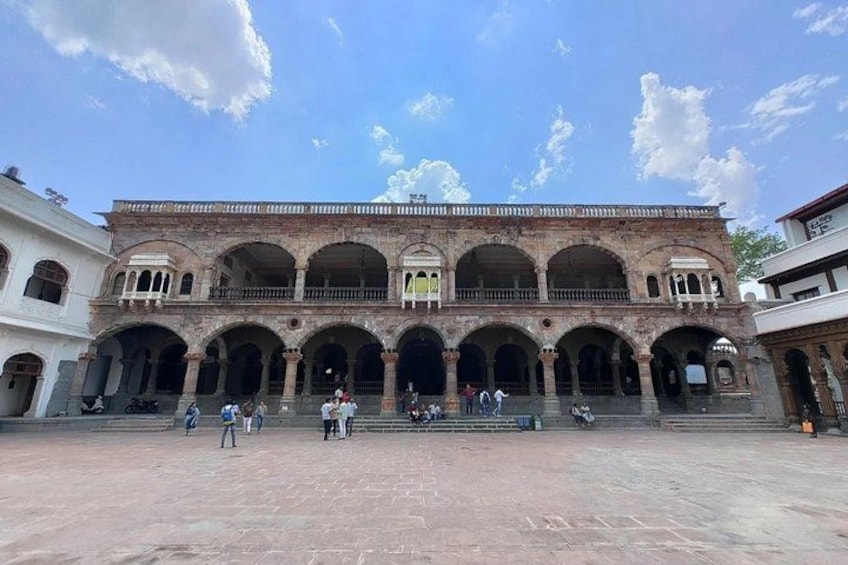 A historic building with multiple arches and a courtyard. 3