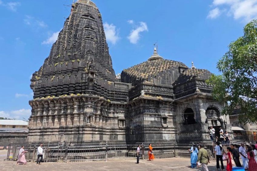 An ancient temple with a tall spire and a smaller dome structure. 5