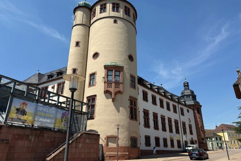 A historic building with two cylindrical towers and a large windowed facade. 3