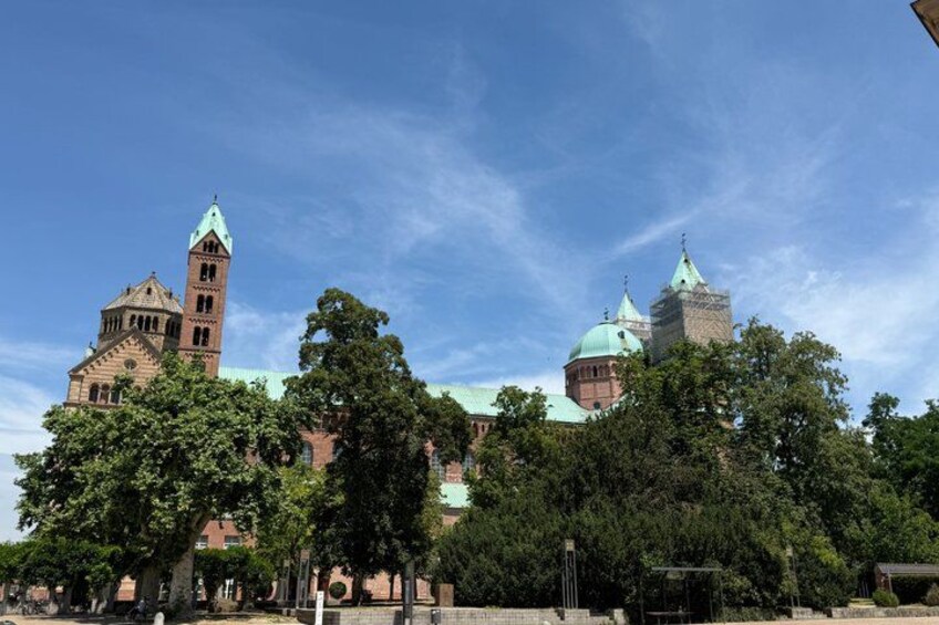 A historic building with a prominent tower and dome, surrounded by trees. 4