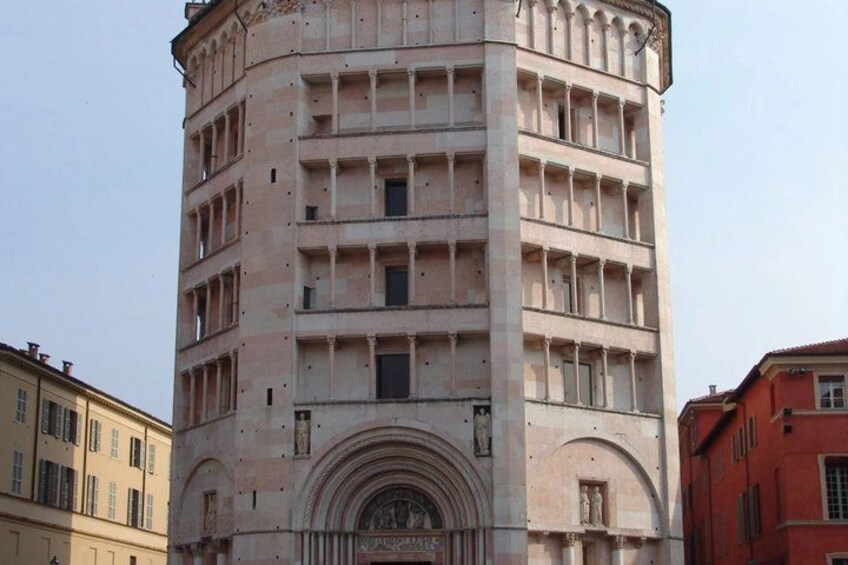 A historic tower with a rounded top, multiple windows, and a decorative entrance. 4