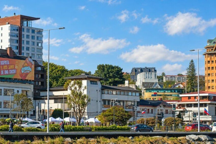 A cityscape with modern buildings, a clear sky, and a pedestrian crossing. 4