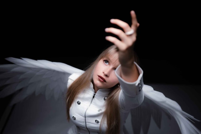 A person with angel wings reaching out. 5