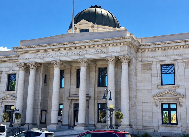 A courthouse with a large dome and columns. 3