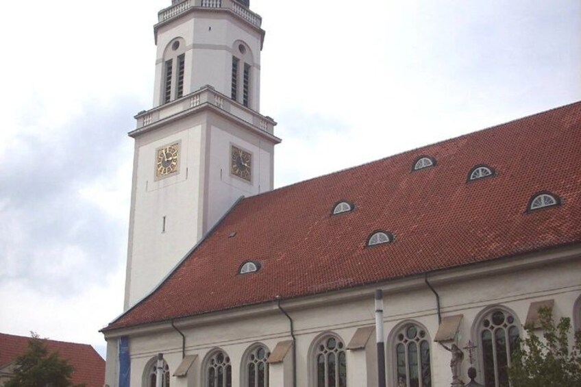 A church with a clock tower and arched windows. 5