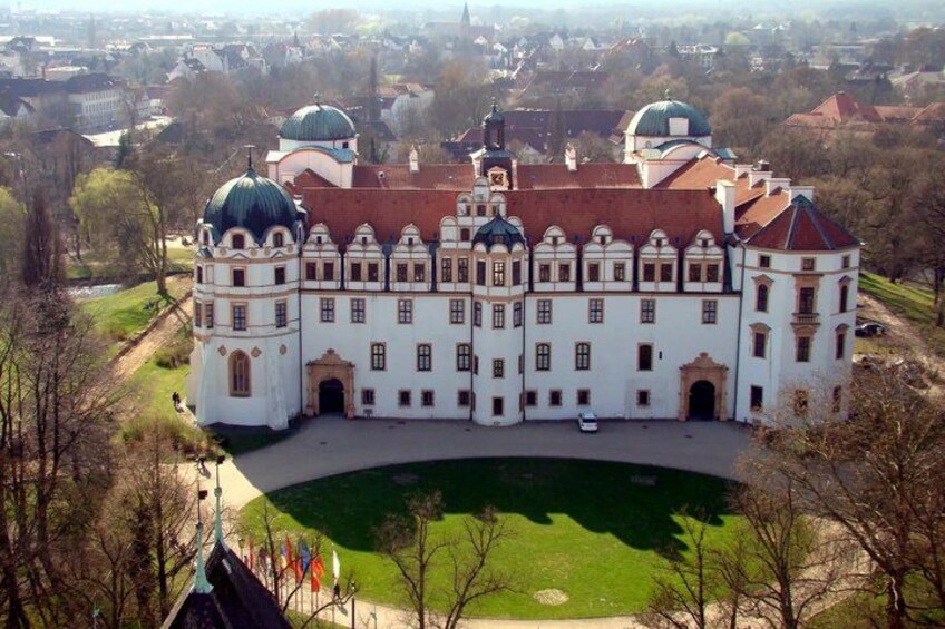 A large white building with domed roofs and a central courtyard. 1