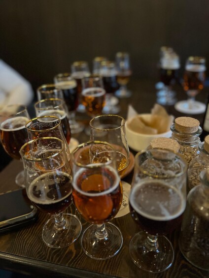 A variety of beer glasses and bottles on a table. 5