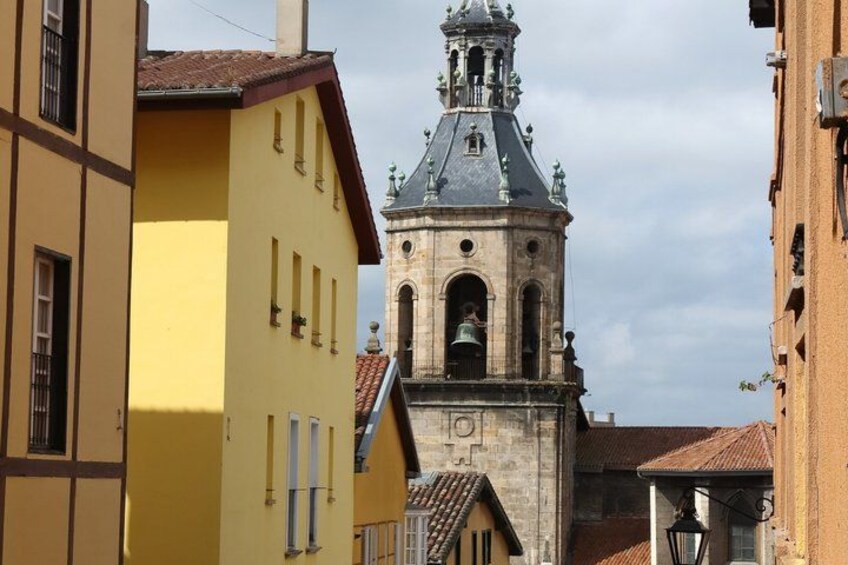 A yellow building with a bell tower in the background. 3