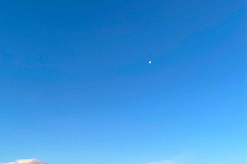 A clear blue sky with a small moon visible. 5