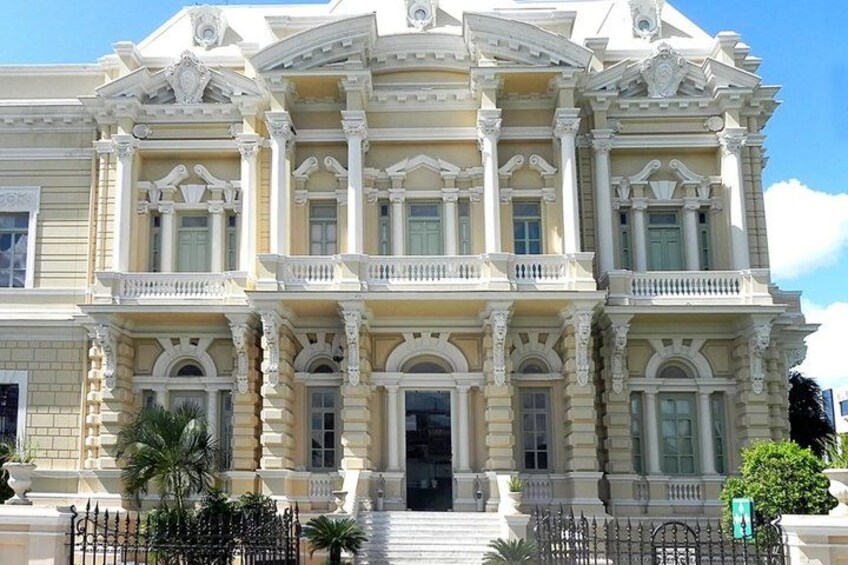 A large, ornate building with multiple balconies and columns. 3
