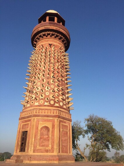 A tall, cylindrical tower with a patterned base and a dome on top. 4