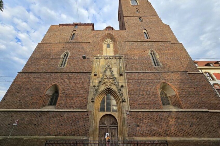 A large brick church with a tall tower and arched windows. 3