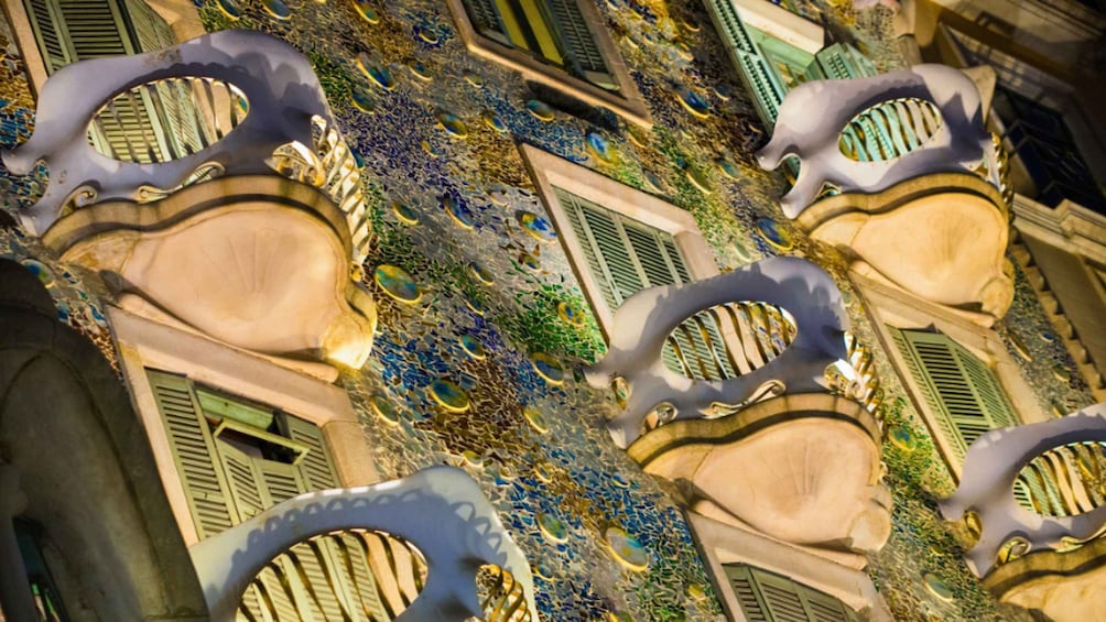 A building with unique, curved window designs and decorative mosaic patterns. 4