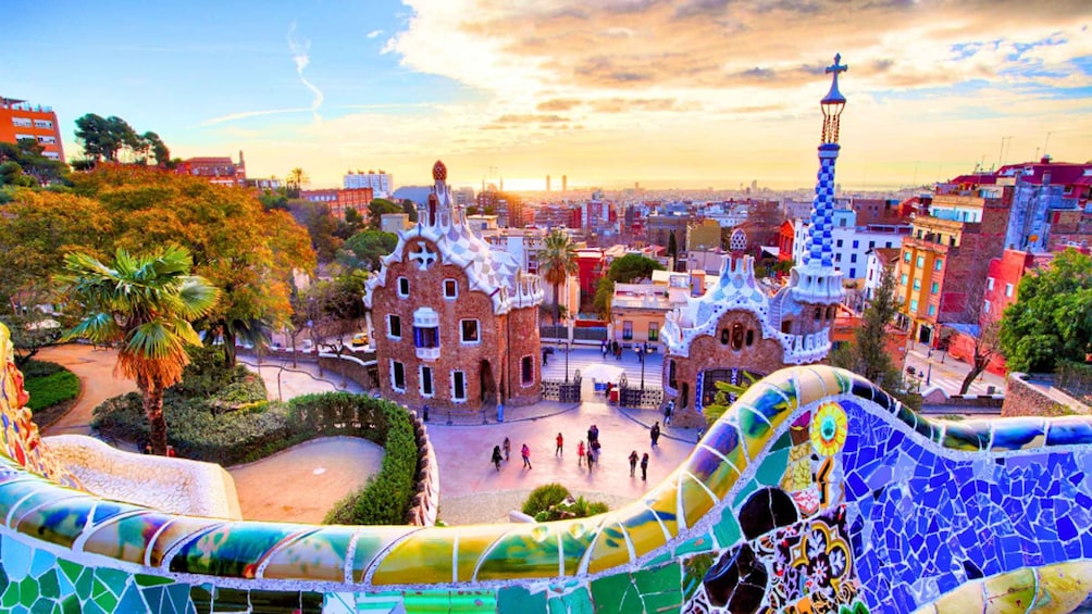 A vibrant cityscape with colorful buildings, including a famous park with a mosaic pathway. 5