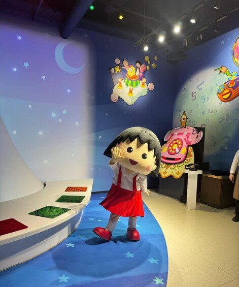 A cartoon character in a red dress standing on a blue floor with stars, a crescent moon, and a rocket ship in the background. 2