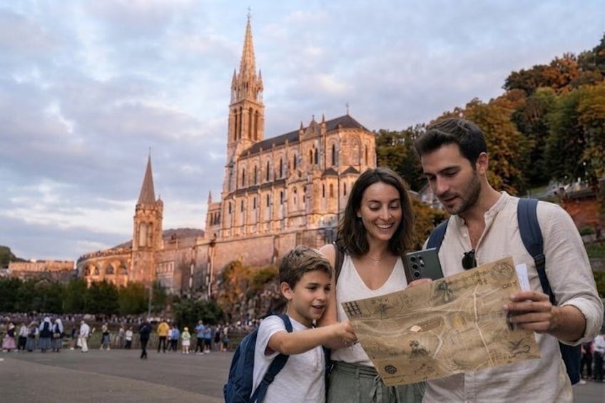 A family with a map in front of a historic cathedral. 1
