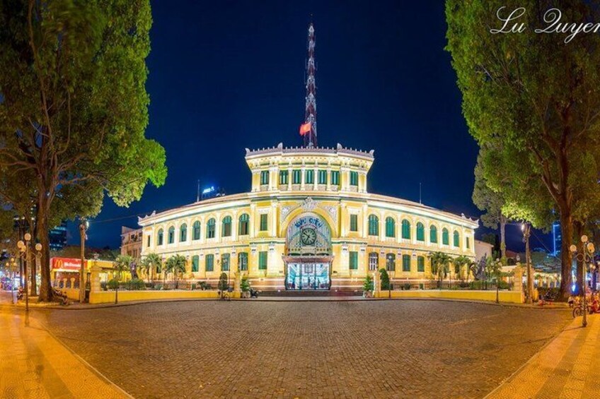 A historic building with a clock tower, surrounded by trees and a cobblestone plaza. 3