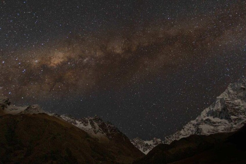 A starry night sky over a mountainous landscape. 4