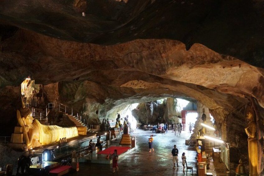 An underground cave with a large statue, a golden tent, and a staircase leading to a higher level. 5