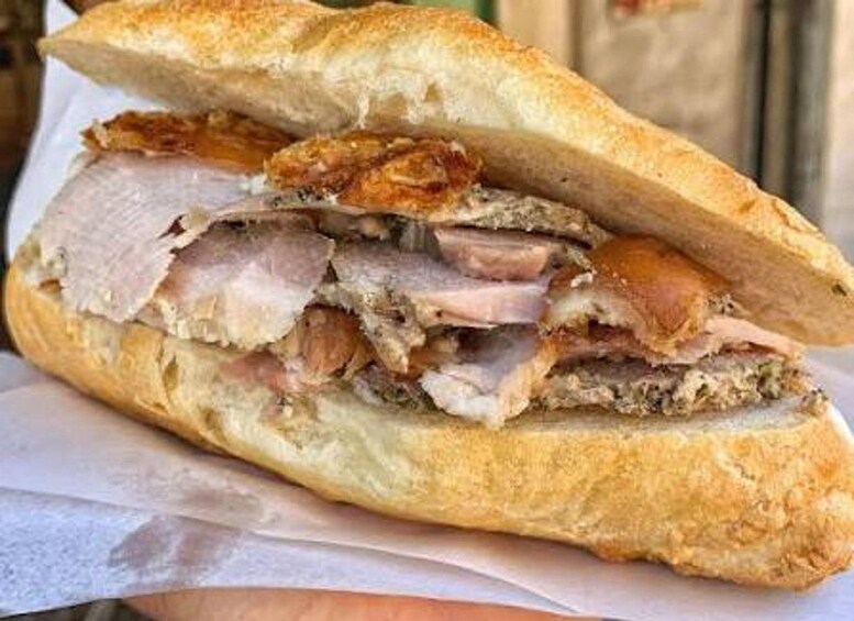 A sandwich with meat and a crusty bread roll. 5