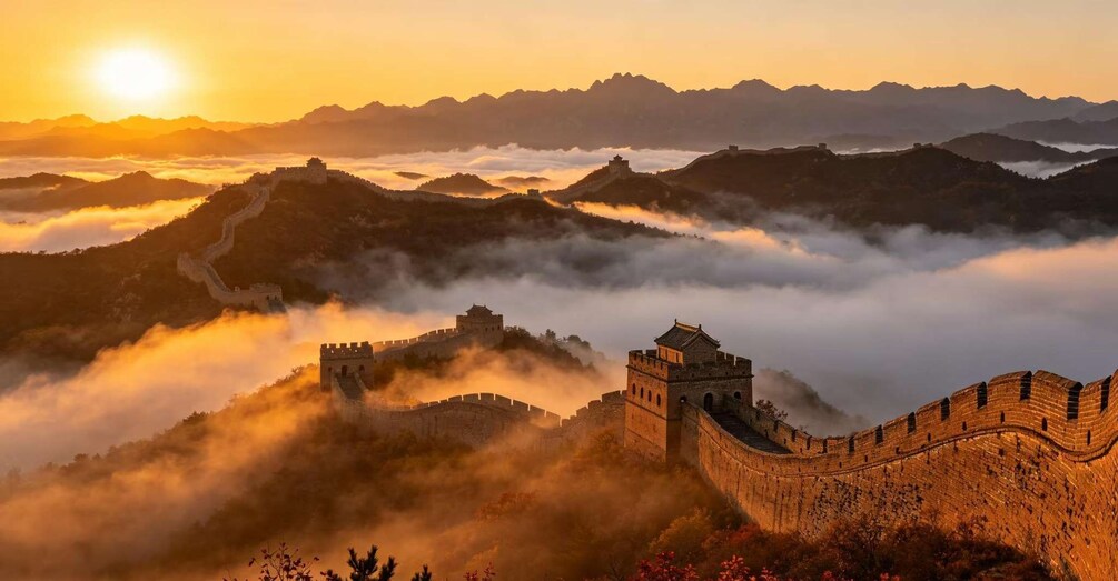 The Great Wall of China at sunrise with mist-covered mountains in the background. 2