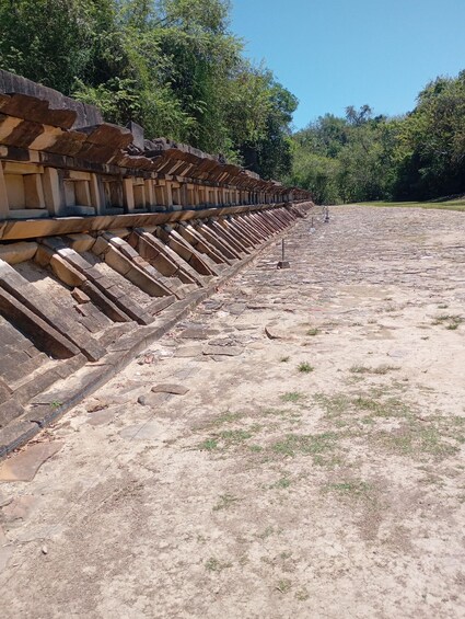 A long stone structure with a series of steps leading up to a flat area. 4