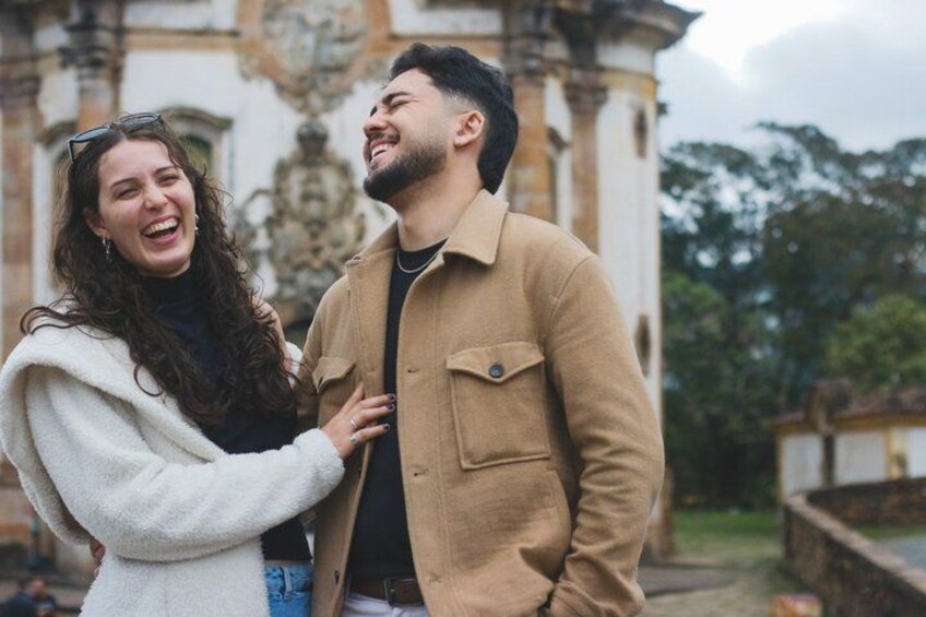 A couple standing in front of a historic building with ornate architecture. 4