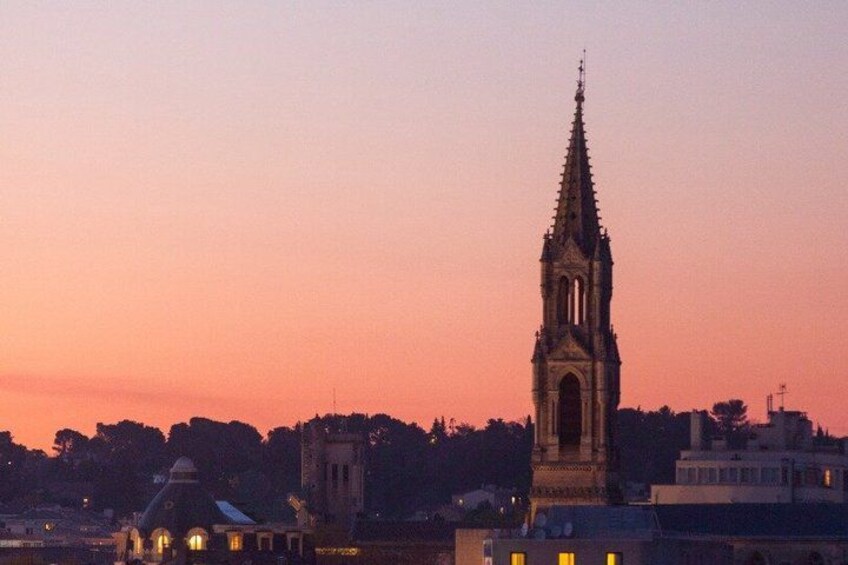 A church tower silhouetted against a sunset sky. 3