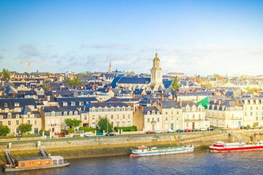 A river with boats, a cityscape with historic buildings, and a prominent tower. 2