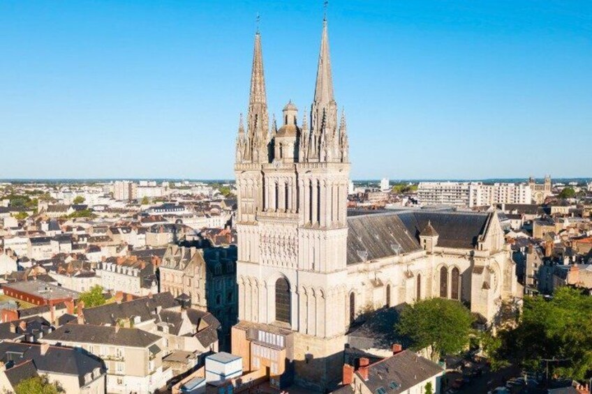 A cathedral with two spires, surrounded by a cityscape. 4