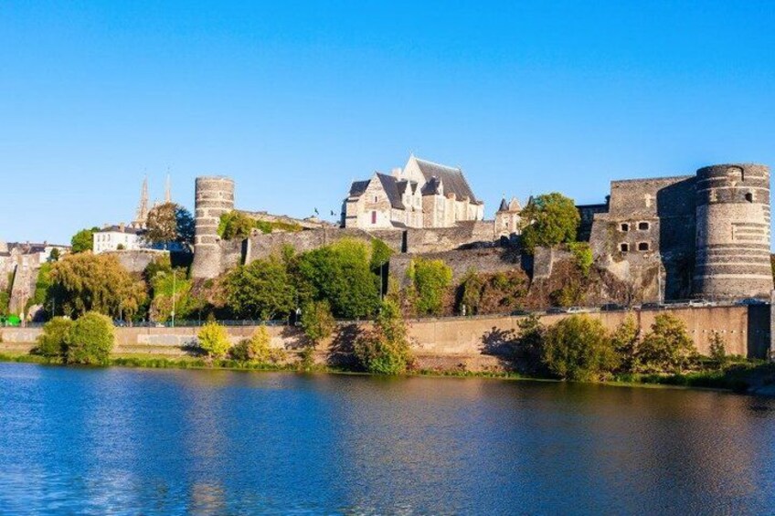A historic castle by a river. 3