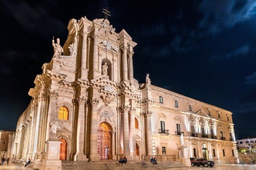 A grand, illuminated church with intricate architecture and a prominent entrance. 5