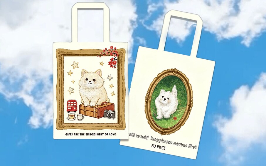 Two tote bags with illustrations of a white cat, a red bus, a camera, and a cup. 1