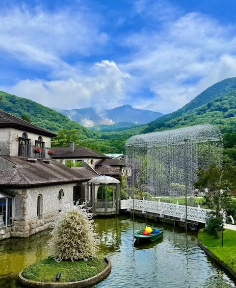 A traditional village with buildings, a bridge, and a river. 1