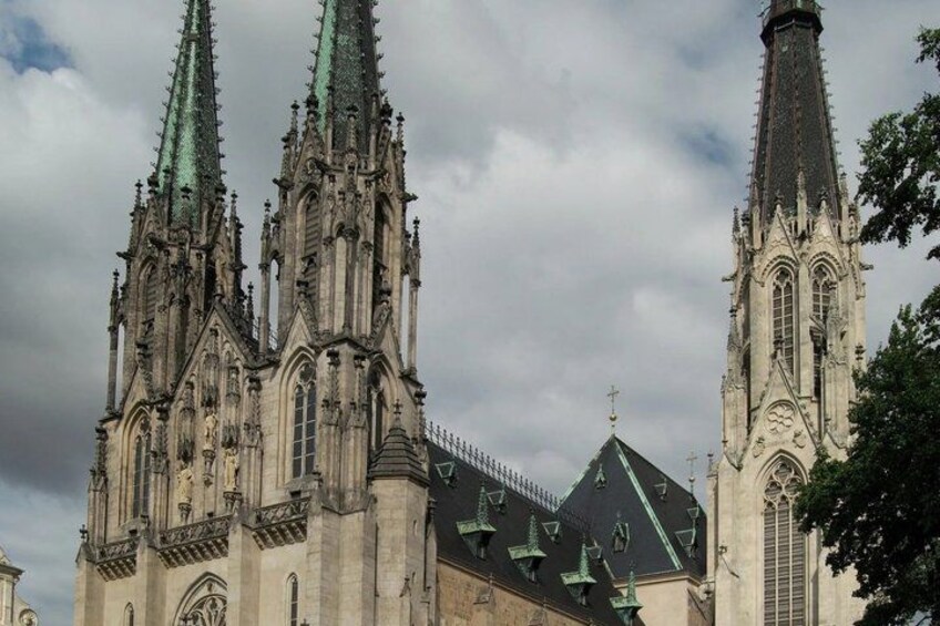 A Gothic-style cathedral with two tall spires and intricate stonework. 2