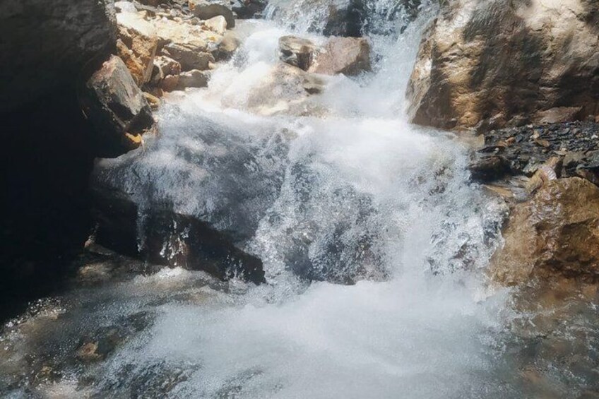 A waterfall cascading over rocks. 1