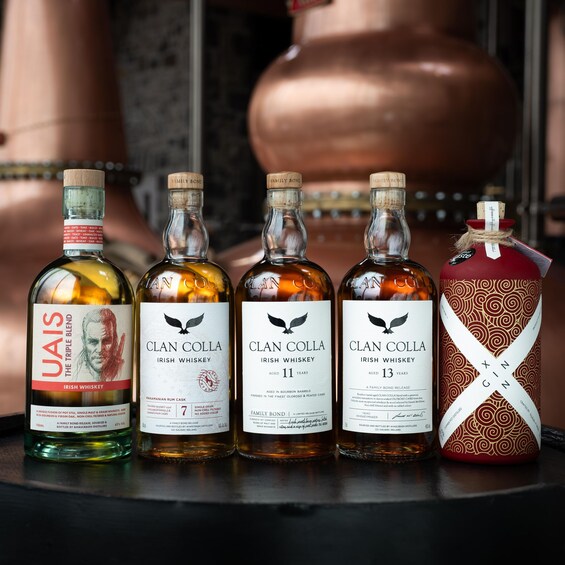 Four bottles of Clan Colla Irish Whiskey and one decorative container. 1