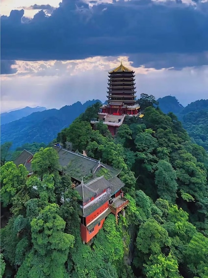 A pagoda-style temple on a mountain peak surrounded by lush greenery. 2