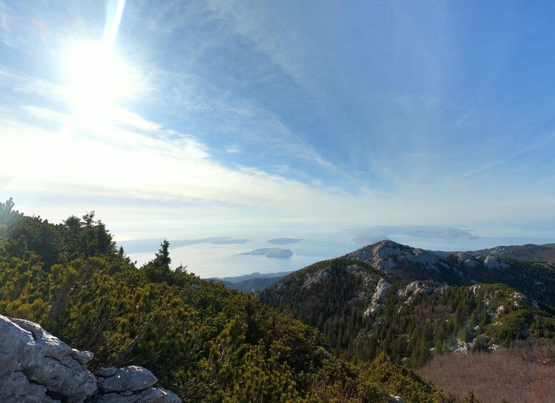 A mountainous landscape with dense forests and a clear sky. 3
